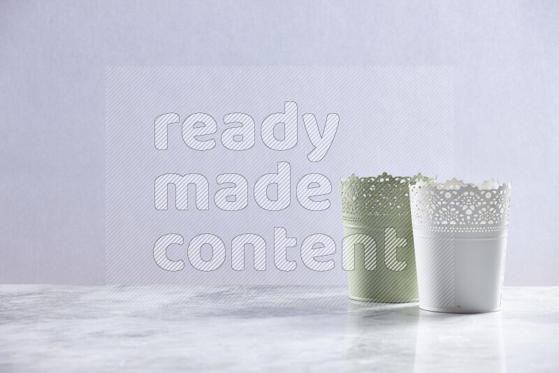 Empty green and white plant pots on grey marble background