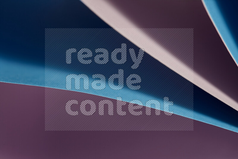 An abstract art showing purple and blue paper sheets arranged in an overlapping curves