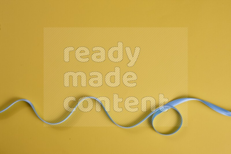 A blue collection of sewing and tailoring tools arranged on a yellow background