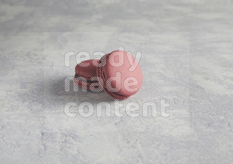 45º Shot of two Red Cherry macarons  on white  marble background