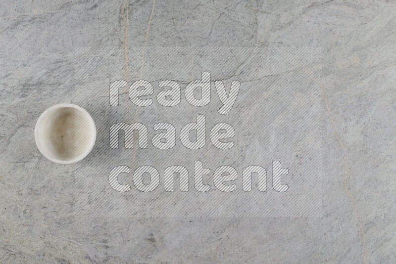 A multicolored pottery Cup on grey marble background