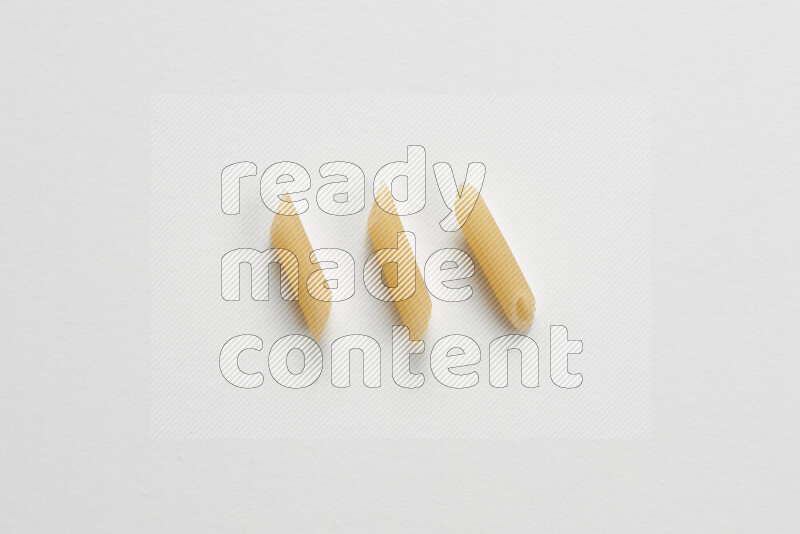 Mini penne pasta on white background