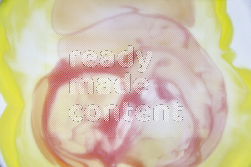 A close-up of abstract swirling patterns in yellow, red and white