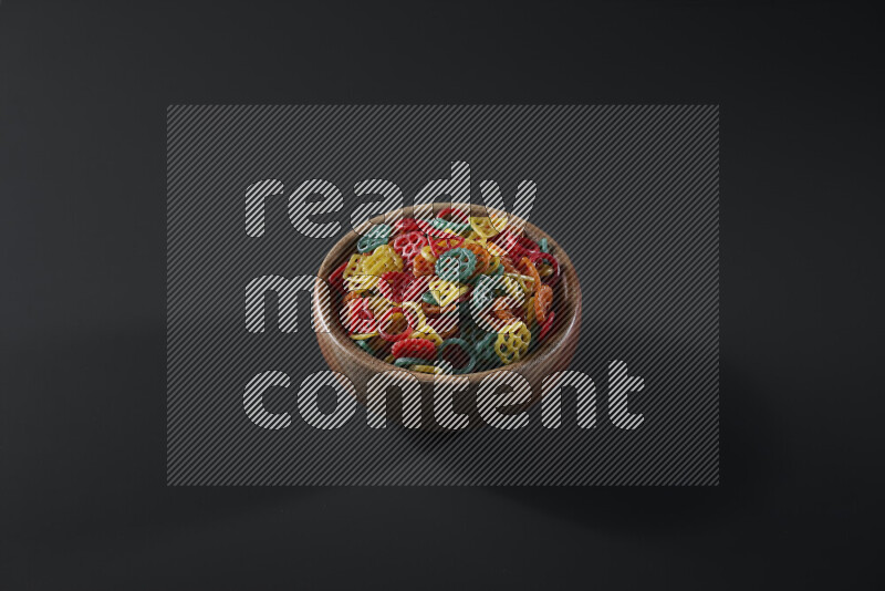 Snacks in a wooden bowl on grey background