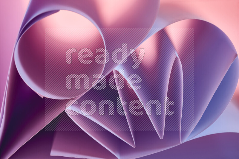 An artistic display of paper folds creating a harmonious blend of geometric shapes, highlighted by soft lighting in purple tones