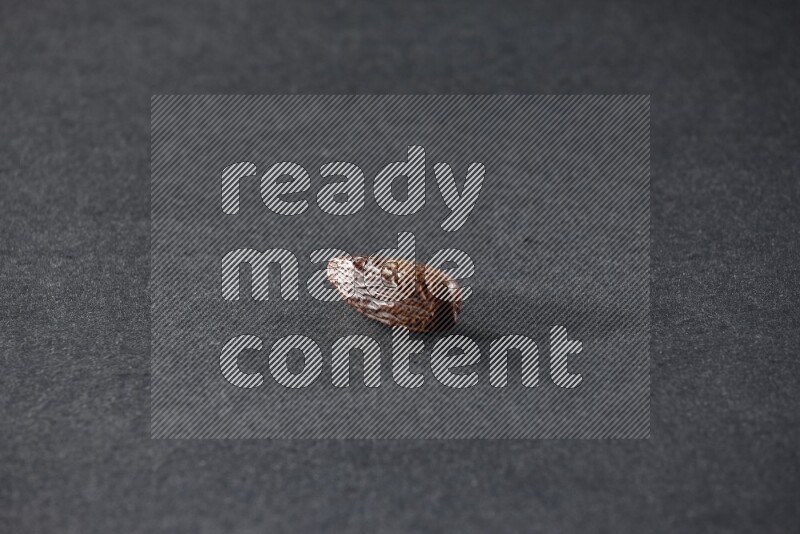 Dried dates on a black background in different angles