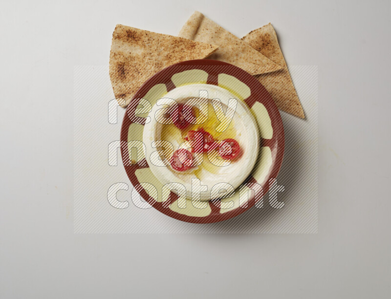 Lebnah garnished with Cherry tomato in a traditional plate on a white background