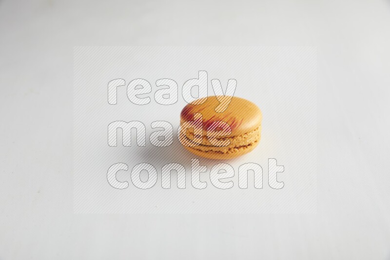 45º Shot of Orange Exotic macaron on white background