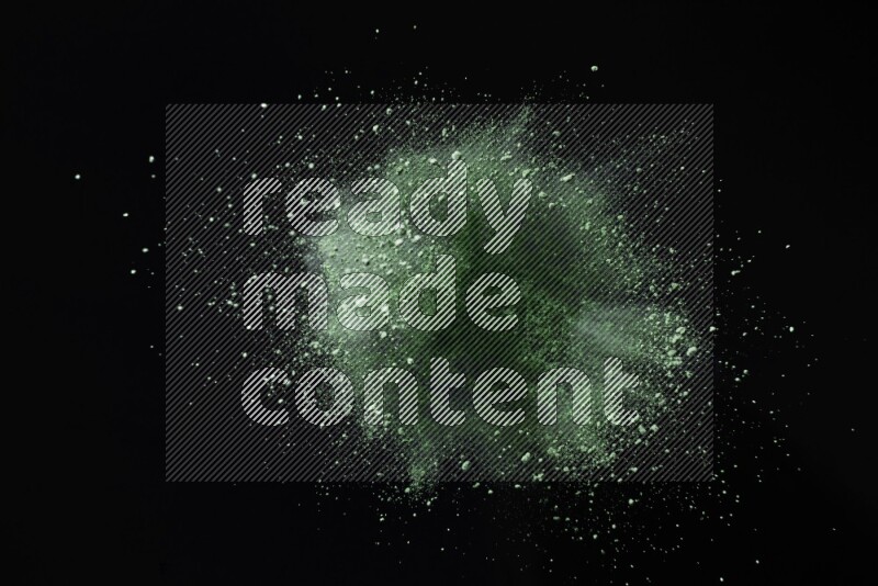 Green powder explosion on black background