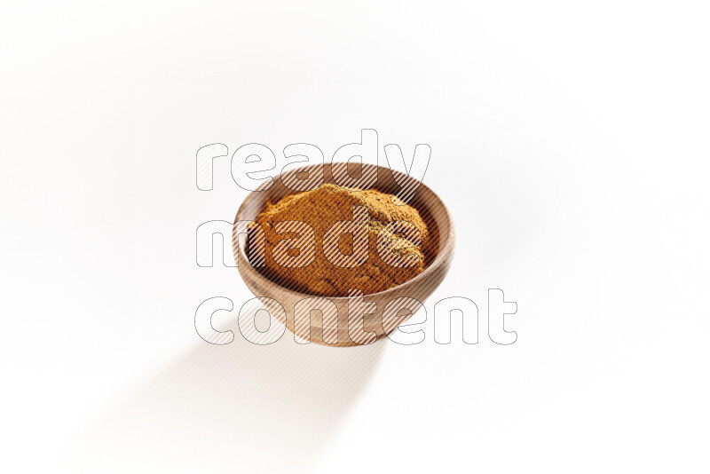 A wooden bowl full of ground paprika powder on white background