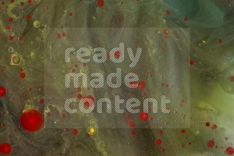 The image captures a dramatic splatter of red, green and yellow paints over the backdrop