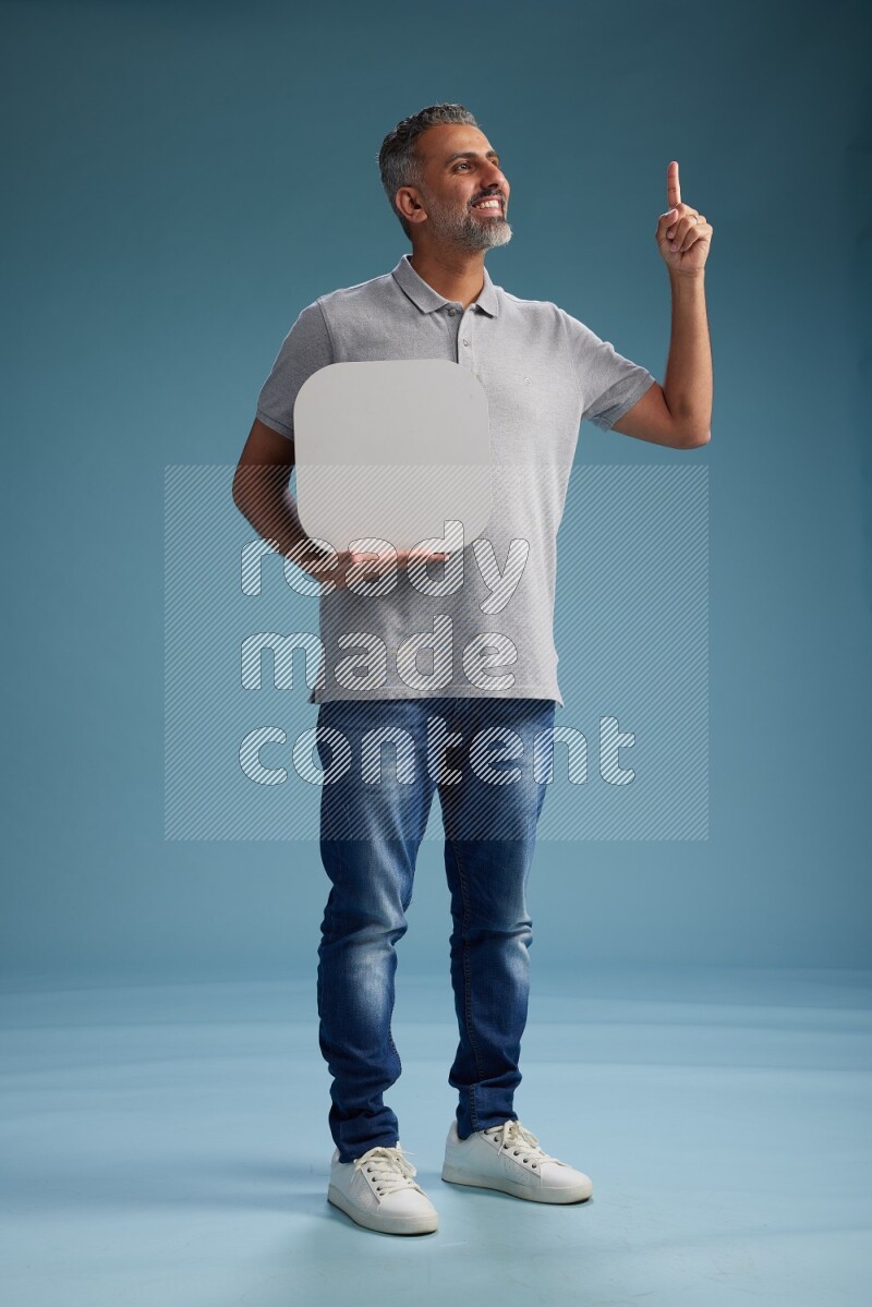Man Standing holding social media sign on blue background