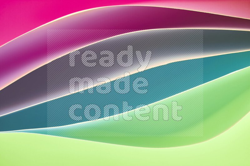 This image showcases an abstract paper art composition with paper curves in green and pink gradients created by colored light