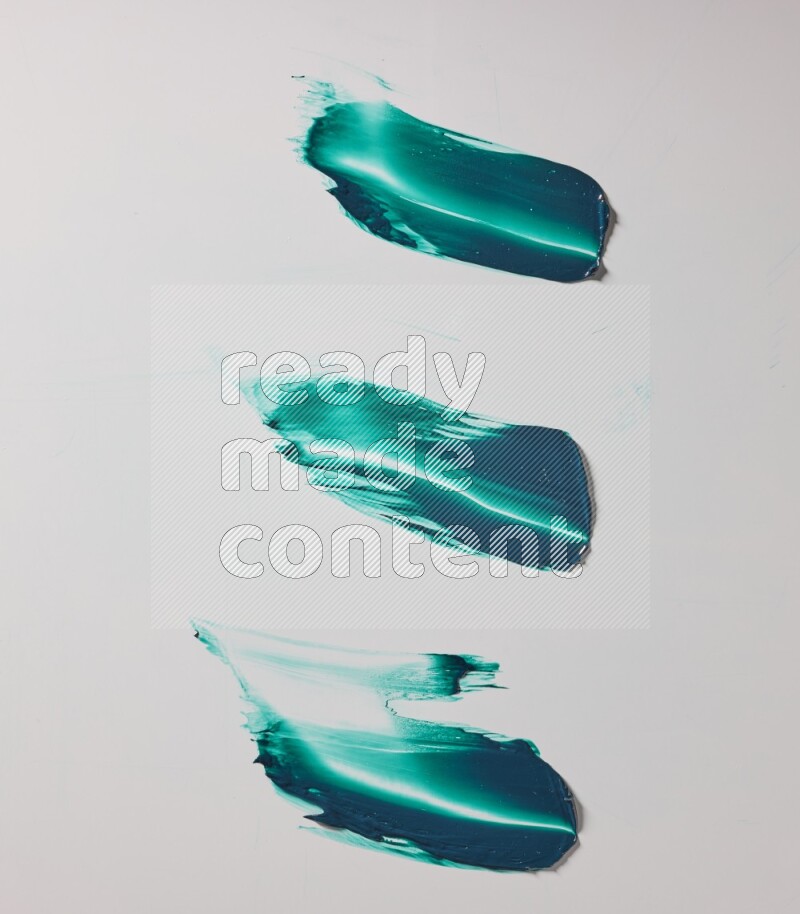 Turquoise painting knife strokes on white background