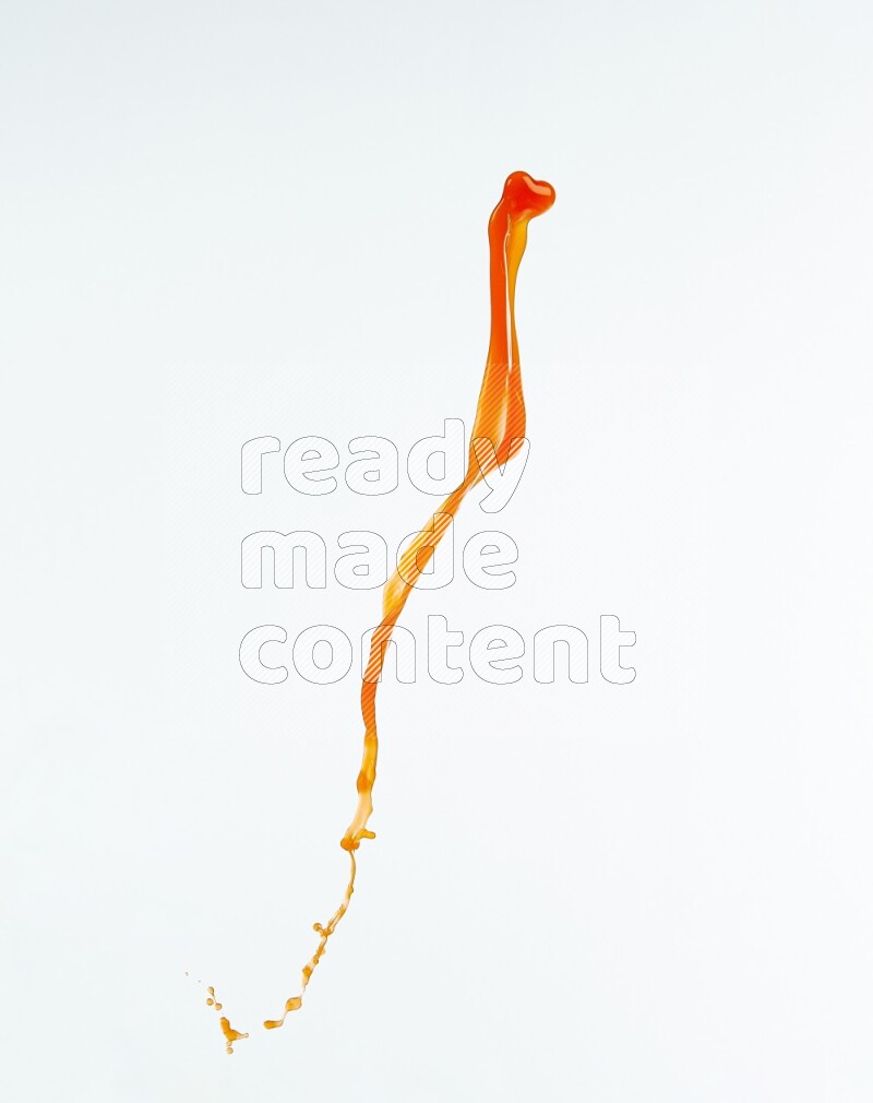 Orange liquid splash and drops on white background