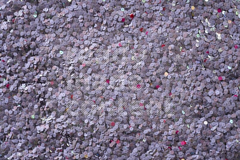 Multicolored flat sequins on grey background
