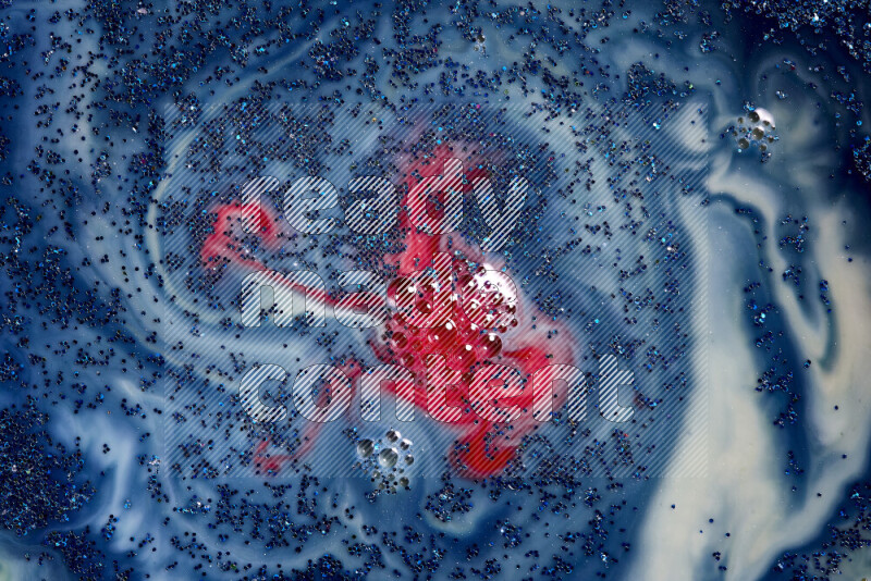 لقطة مقربة لبريق أزرق متلألئ منتشر على خلفية من اللون الأزرق والأحمر في حركات دائرية