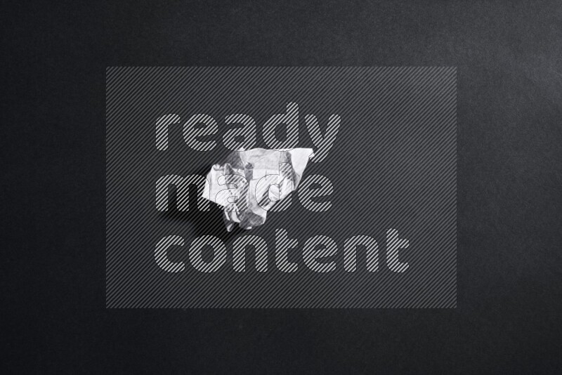 Crumpled notebook sheet on black background
