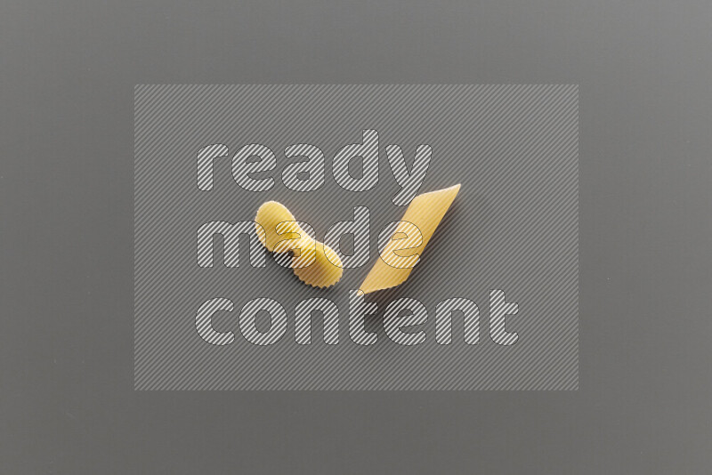 Fiocchi pasta with other types of pasta on grey background