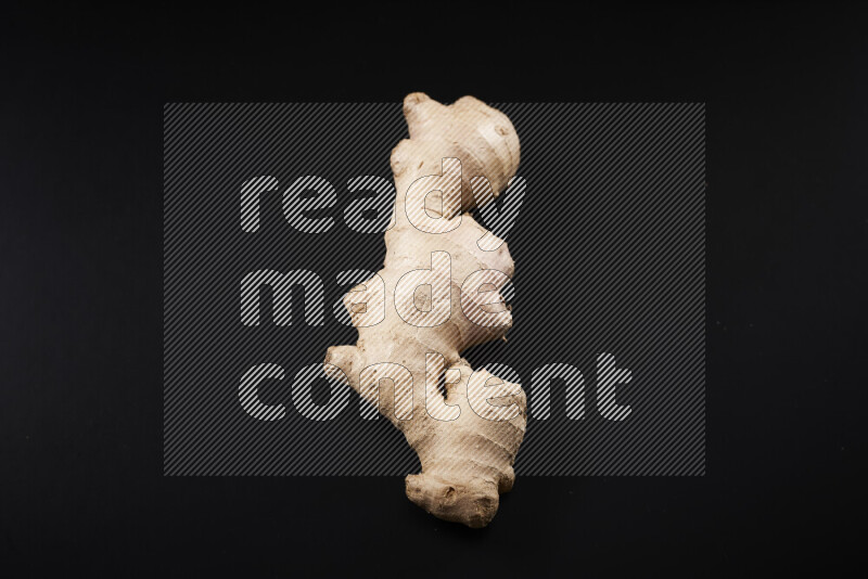 Fresh ginger root on black background