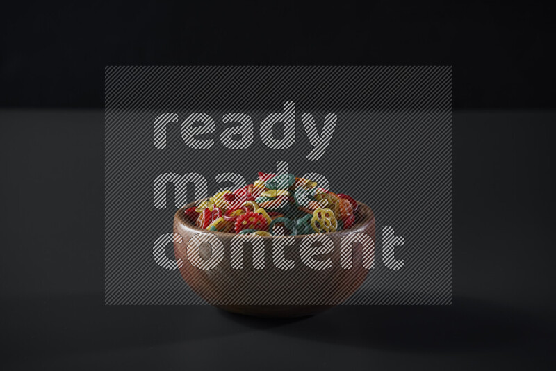Snacks in a wooden bowl on grey background