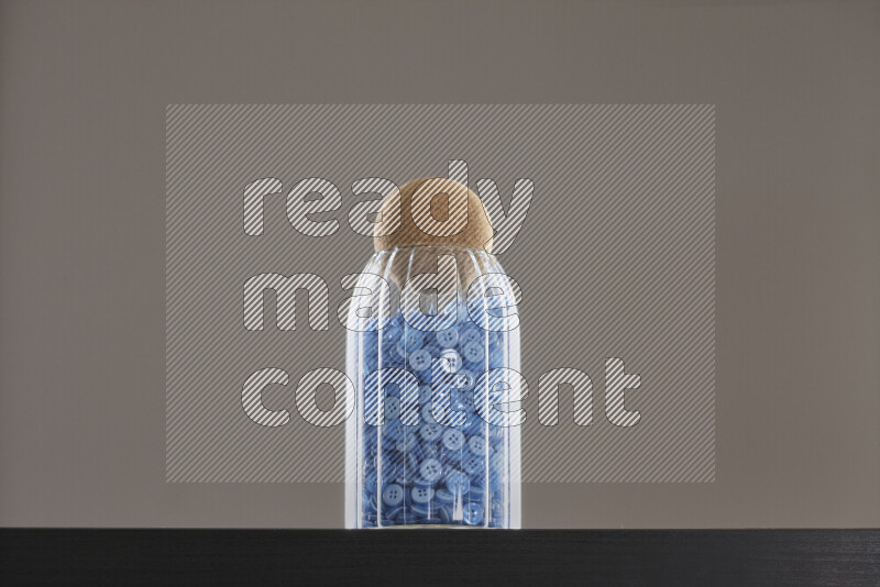Buttons in a glass jar on black background