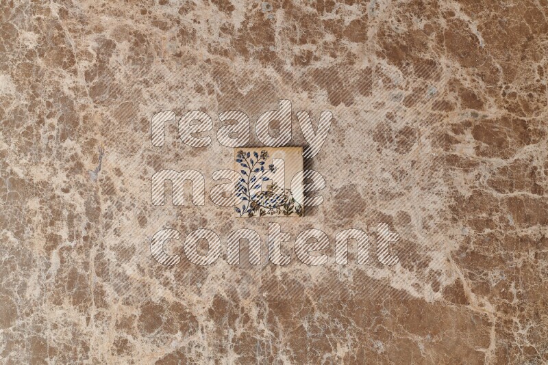 A decorative coaster on beige marble background