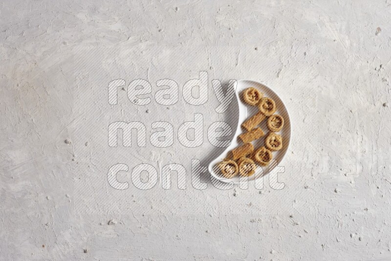Oriental sweets in a pottery plate in a light setup