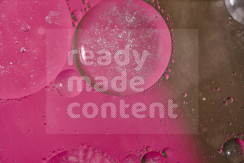 Close-ups of abstract oil bubbles on water surface in shades of pink and brown
