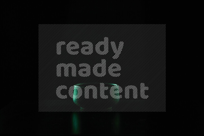 Black pottery bowls with colored rim light against black background