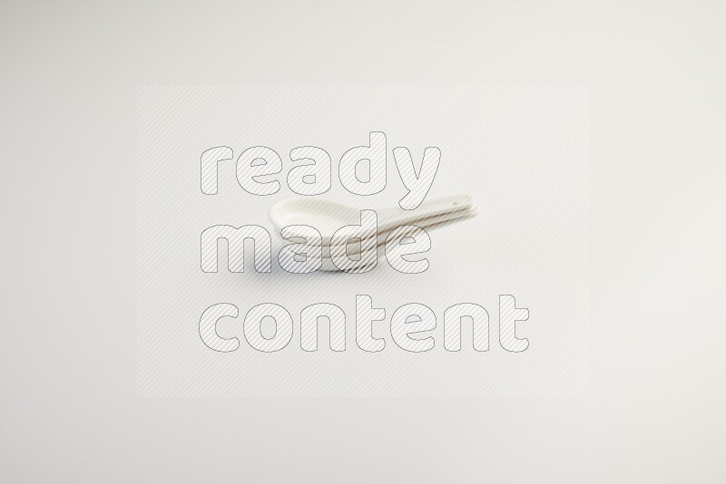 white ceramic soup spoon on white countertop