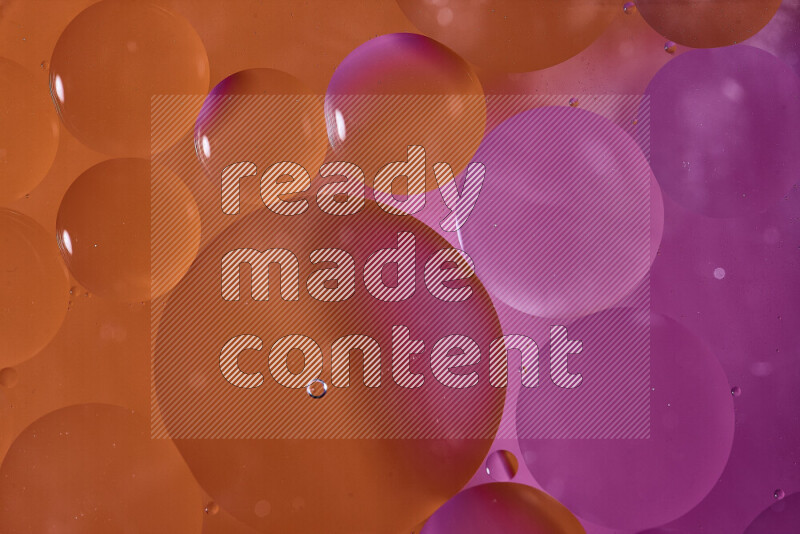 لقطات مقربة لفقاعات من الزيت على سطح الماء باللون البرتقالي والوردي