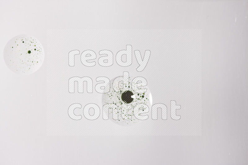 Close-ups of abstract green paint droplets on the surface