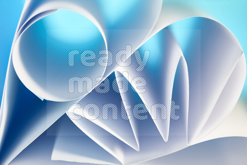 An artistic display of paper folds creating a harmonious blend of geometric shapes, highlighted by soft lighting in blue and white tones