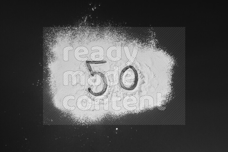 Numbers written with powder on black background