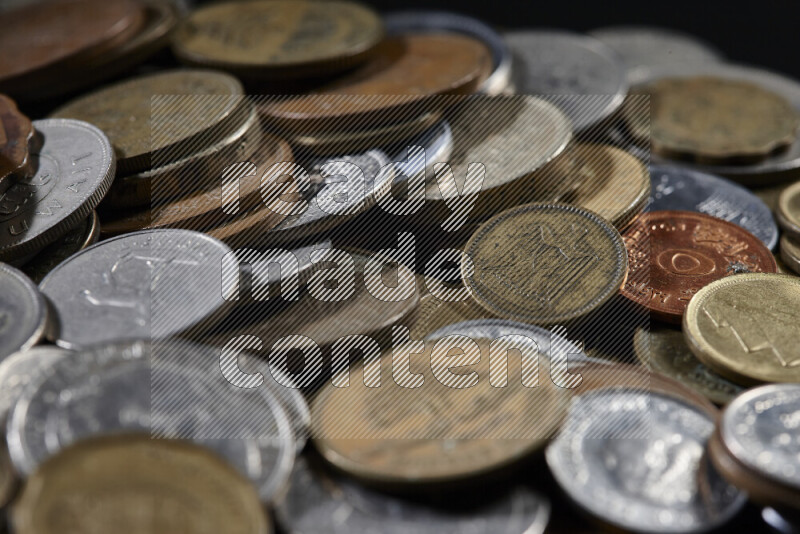 A close-ups of random old coins on black background