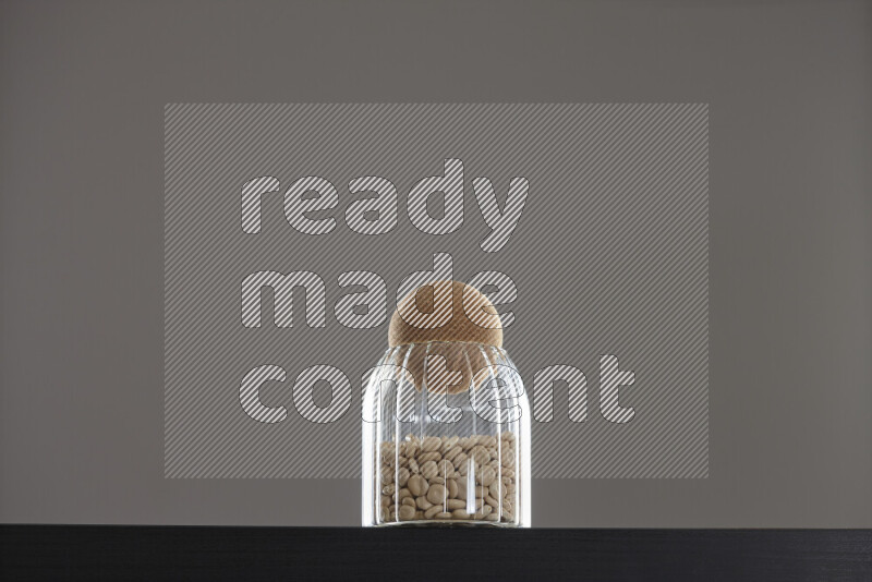 Lupin Beans in a glass jar on black background