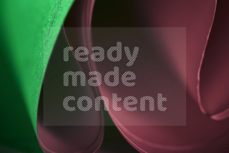 An abstract art piece displaying smooth curves in pink and green gradients created by colored light