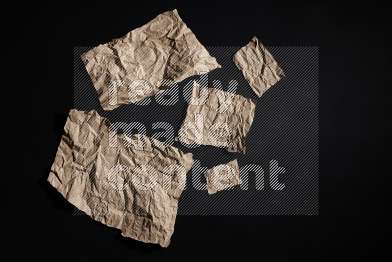 Crumpled craft paper on black background
