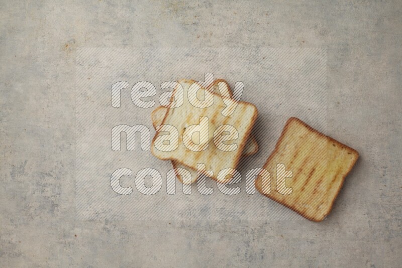 Toasted White Toast slices with a butter curl on a light blue textured background