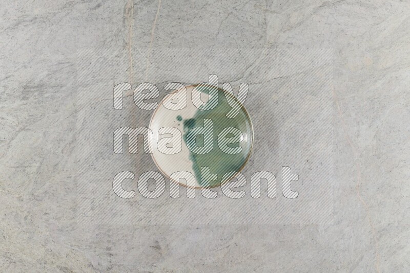 A multicolored pottery Bowl on grey marble background