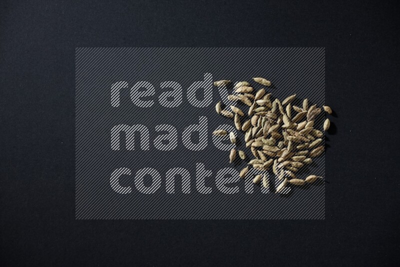 Cardamom seeds on black flooring