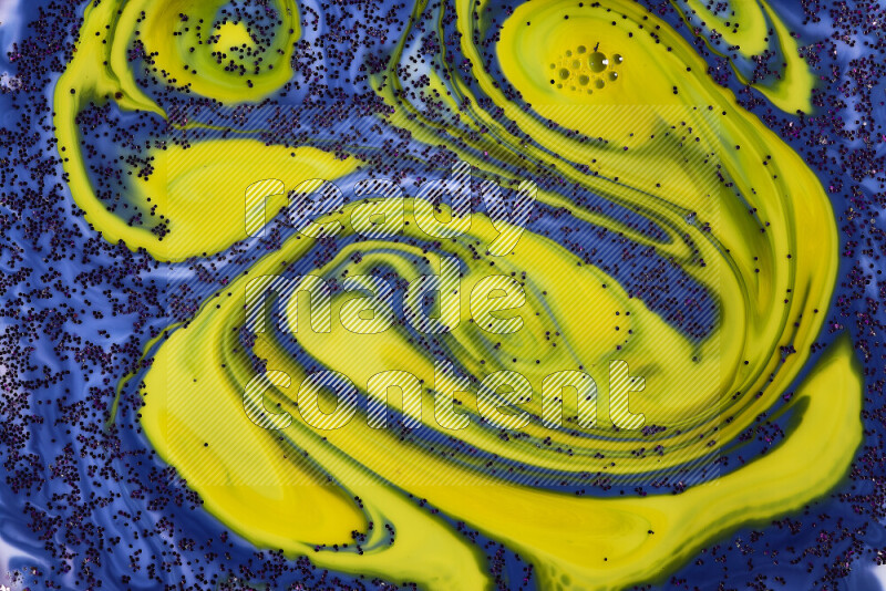 A close-up of sparkling purple glitter scattered on swirling blue and yellow background