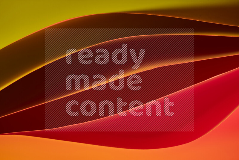 هذه الصورة تعرض تكوين فن الورق التجريدي مع منحنيات ورقية بتدرجات لونية دافئة مختلفة المكونه بواسطة الضوء الملون