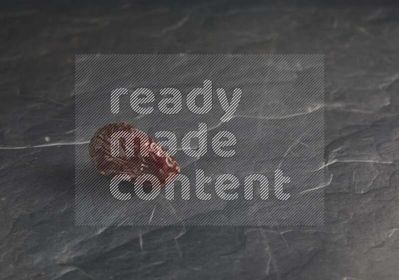 one madjoul date on a black textured background