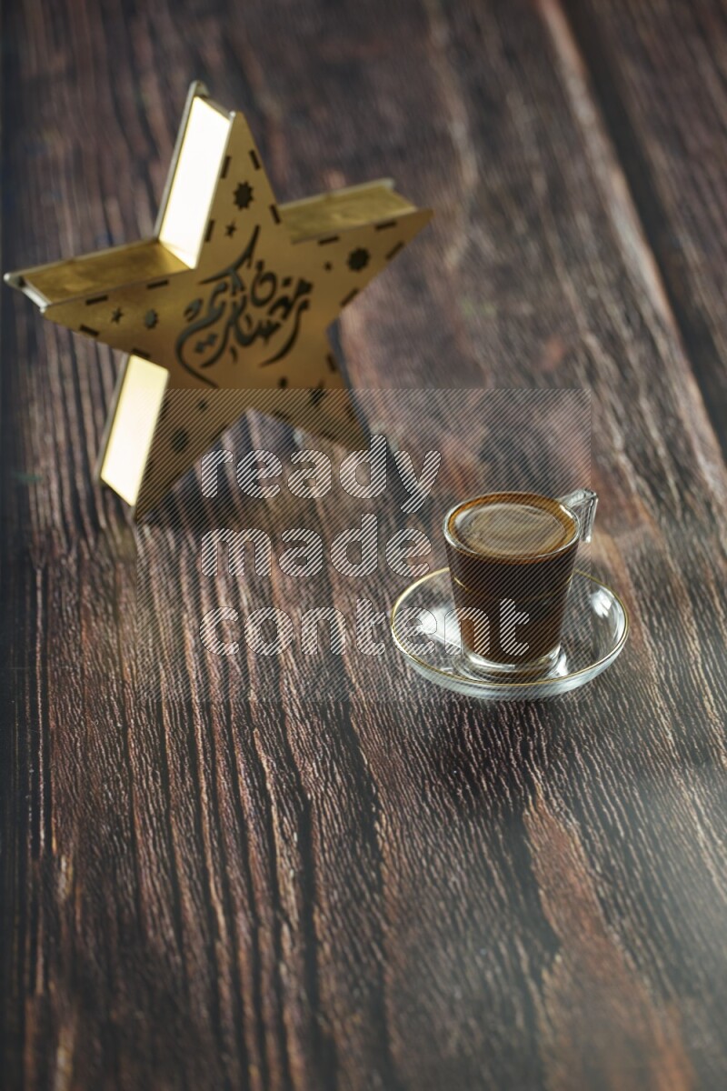 A wooden golden star lantern with different drinks, dates, nuts, prayer beads and quran on brown wooden background