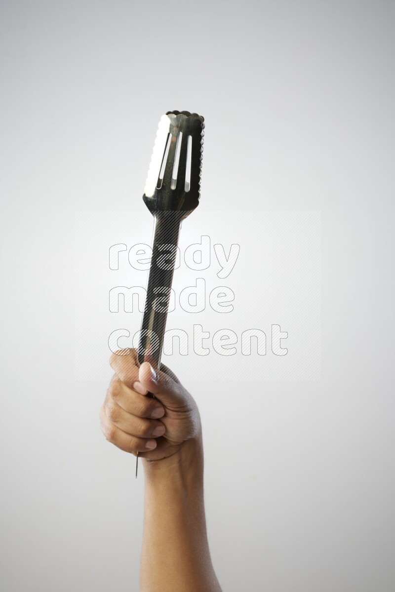 Male Hand Holding Tongs on white background