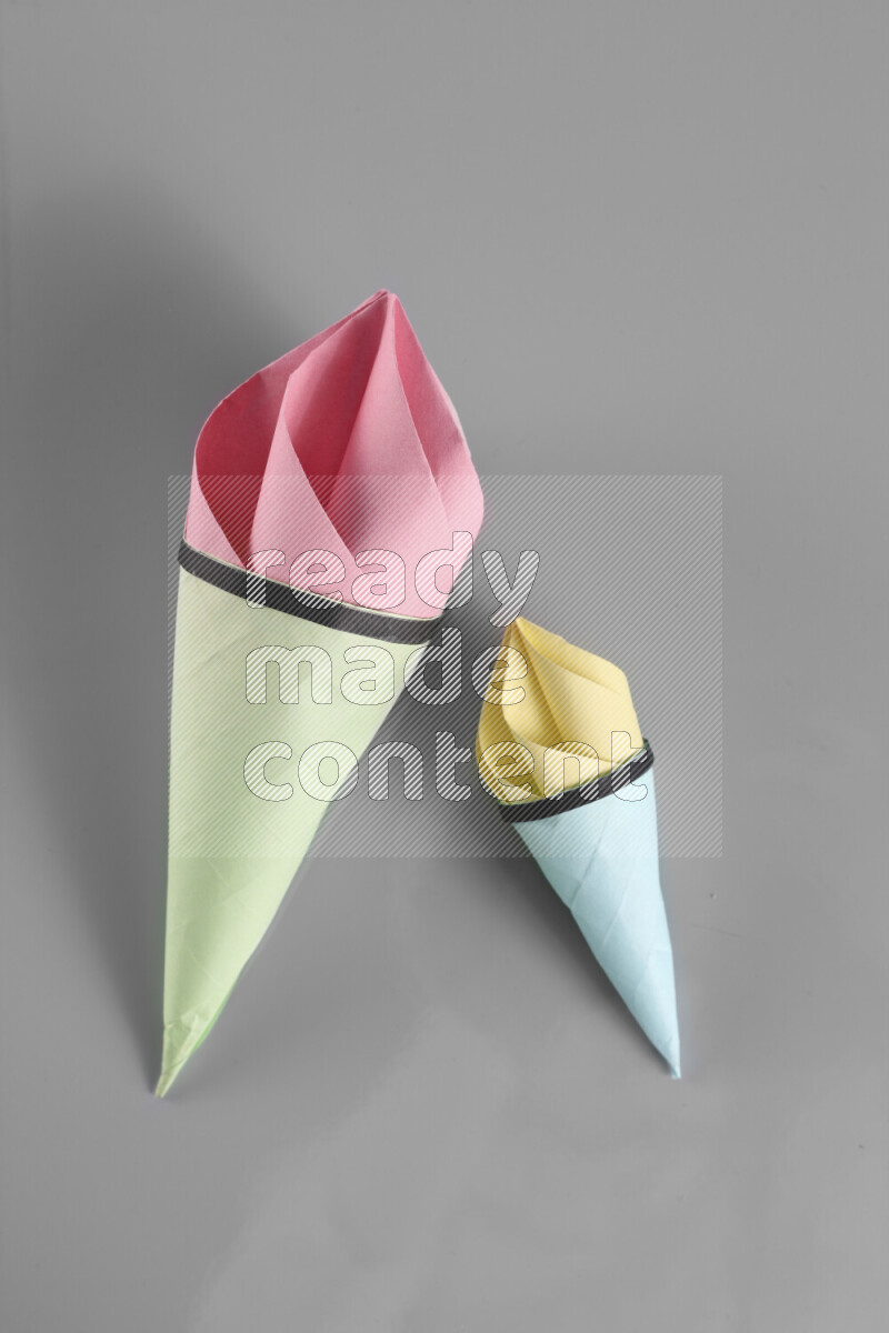 Origami ice cream on grey background