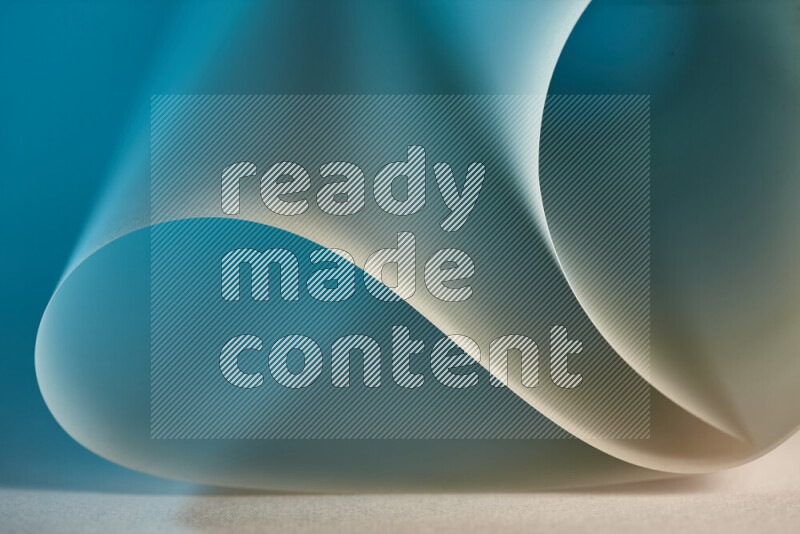 An abstract art piece displaying smooth curves in blue and gold gradients created by colored light