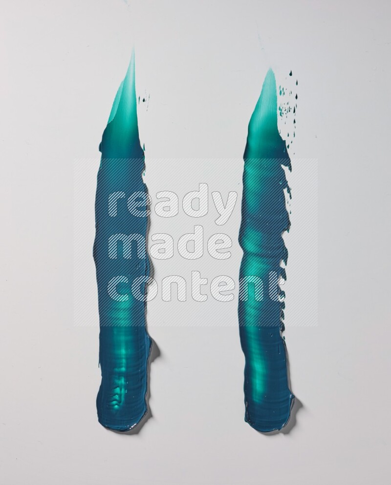 Turquoise painting knife strokes on white background